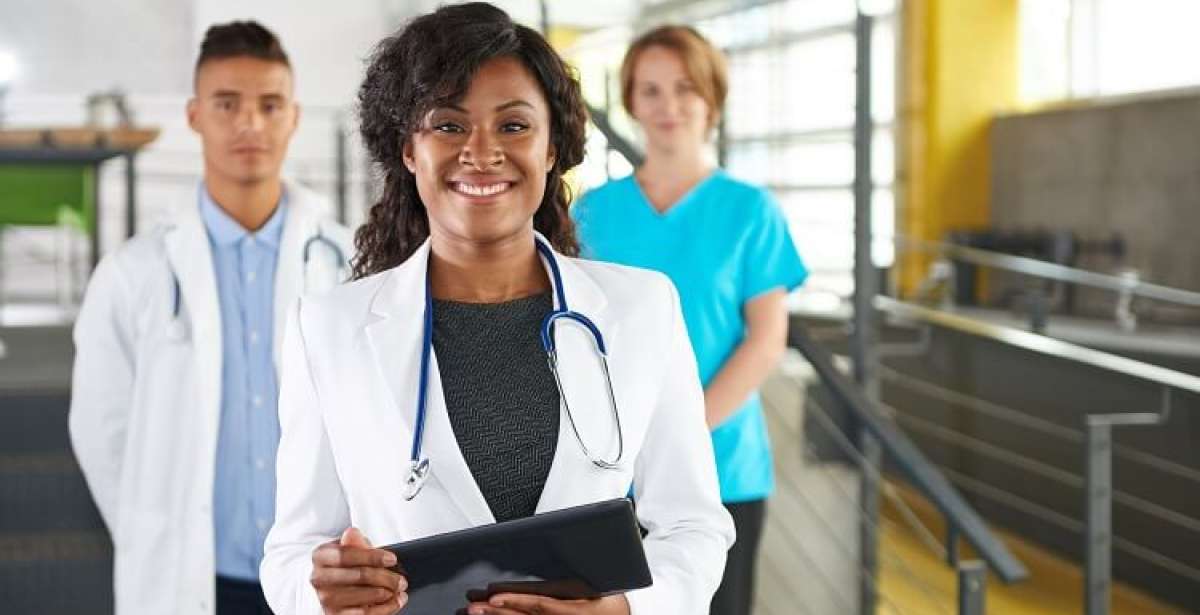 Doctors smiling holding a tablet